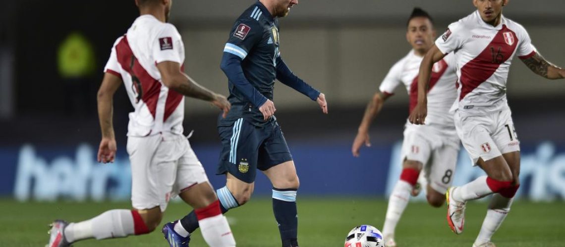 Argentina's Lionel Messi, center, controls the ball during a qualifying soccer match for the FIFA World Cup Qatar 2022 against Peru at Monumental Antonio Vespucio Liberti stadium in Buenos Aires, Argentina, Thursday, Oct.14, 2021. (AP Photo/Gustavo Garello)