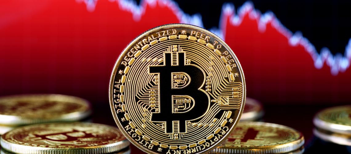 ?stanbul, Turkey - January 24, 2018: Close up shot of bitcoin memorial coin a financial drop graph. Bitcoin is a crypto currency and a worldwide payment system.